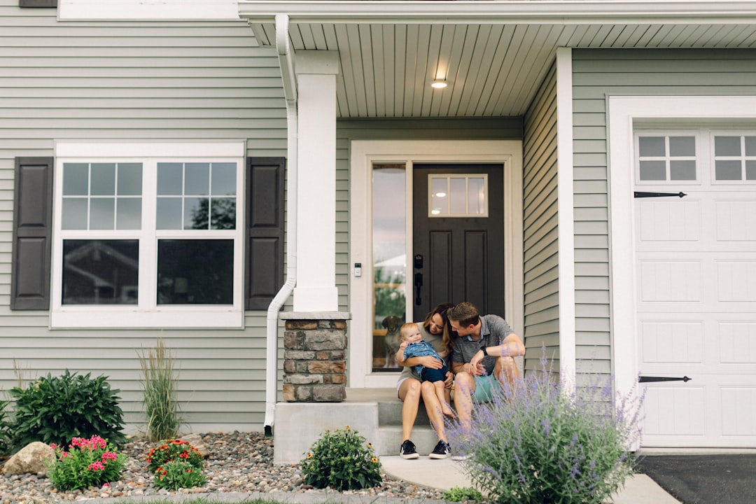 Veteran family in front of new construction home